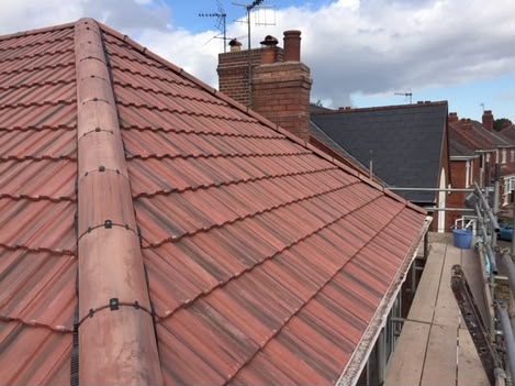 Close-up of dry verge detailing and interlocking tiles on a completed roof in Aylesbury, Buckinghamshire